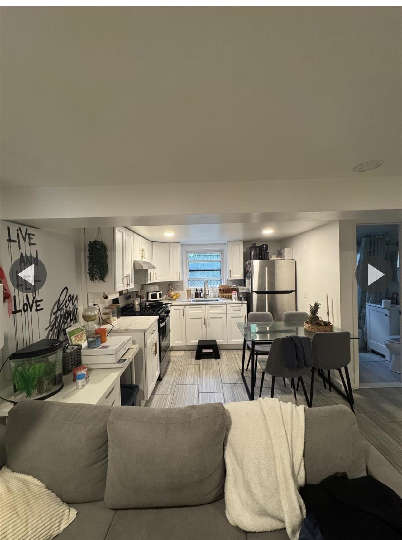 315 22nd Street Union City, NJ 07087 - Photo 10 of 11 a living room with furniture kitchen view and a window