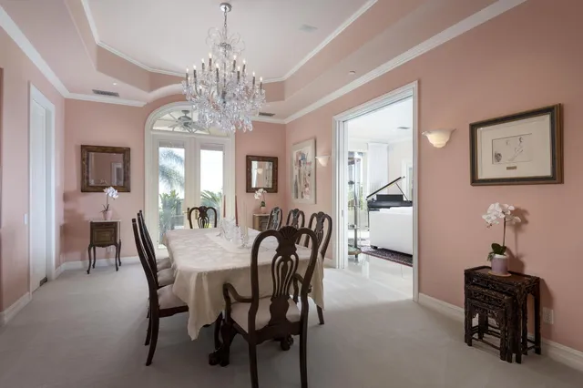 a bedroom with a bed a desk and a chandelier