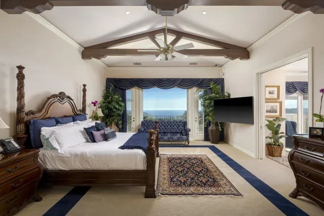 a bathroom with a granite countertop sink a toilet a mirror and shower