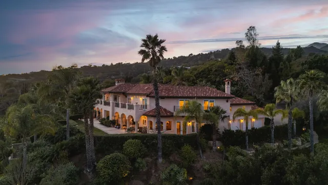 a view of swimming pool with palm trees