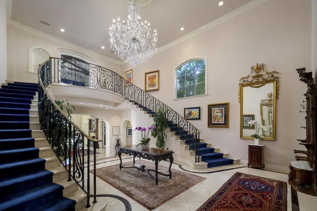 a living room with furniture floor to ceiling window and couch