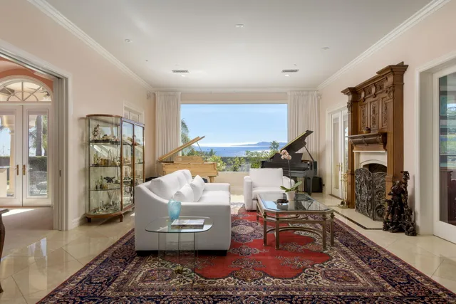 a view of a dining room with furniture and a chandelier