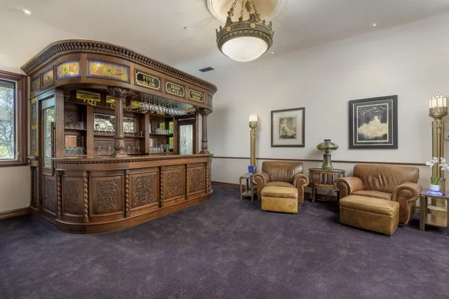 a large living room with stainless steel appliances kitchen island granite countertop furniture and a kitchen view