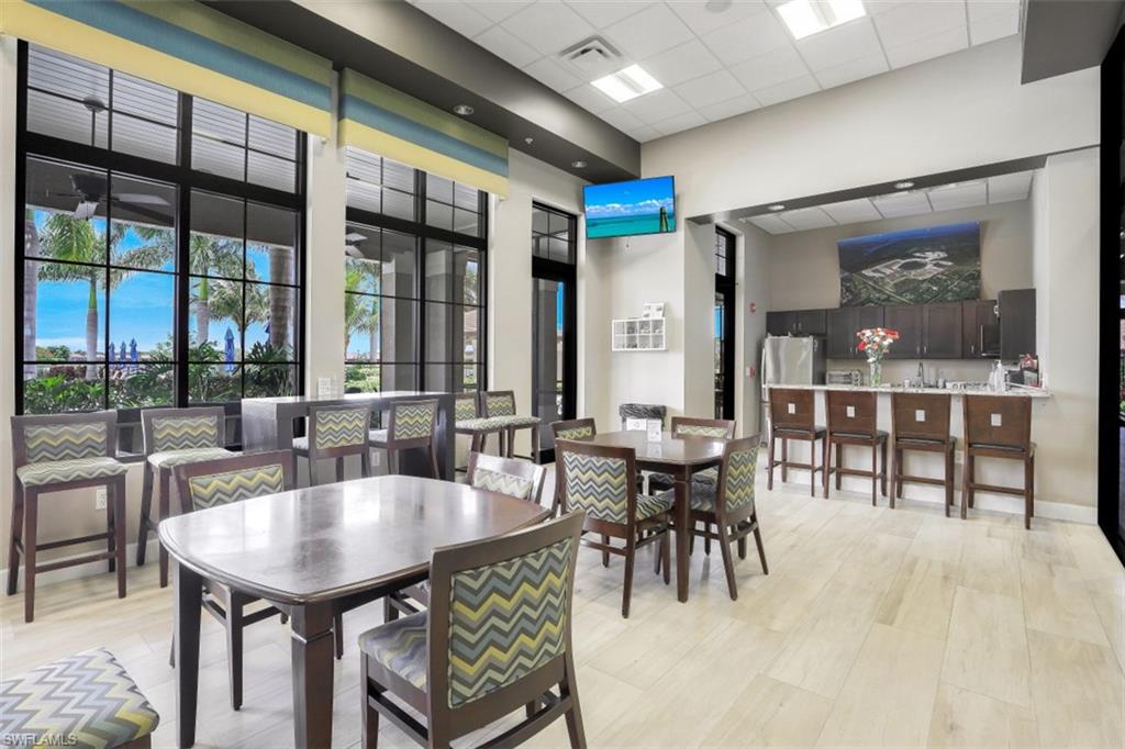 1316 Kendari Terrace Naples, FL 34113 - Photo 28 of 31 a dining hall with furniture a large window and kitchen view