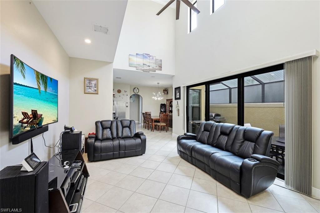 1316 Kendari Terrace Naples, FL 34113 - Photo 4 of 31 a living room with furniture and a flat screen tv