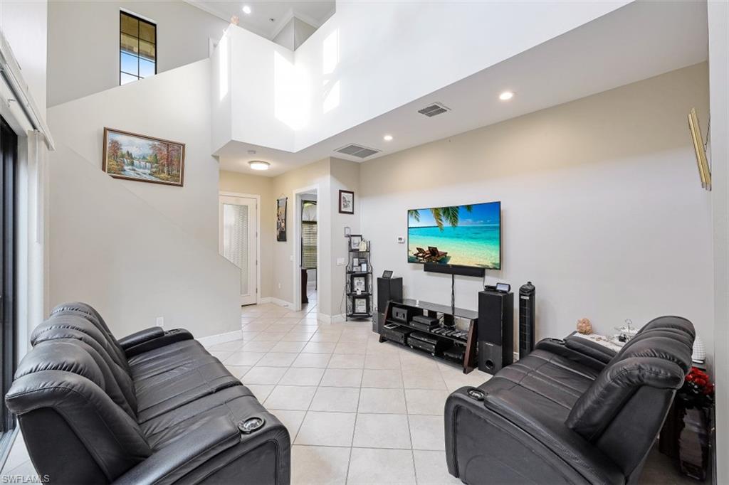 1316 Kendari Terrace Naples, FL 34113 - Photo 5 of 31 a living room with furniture and a flat screen tv