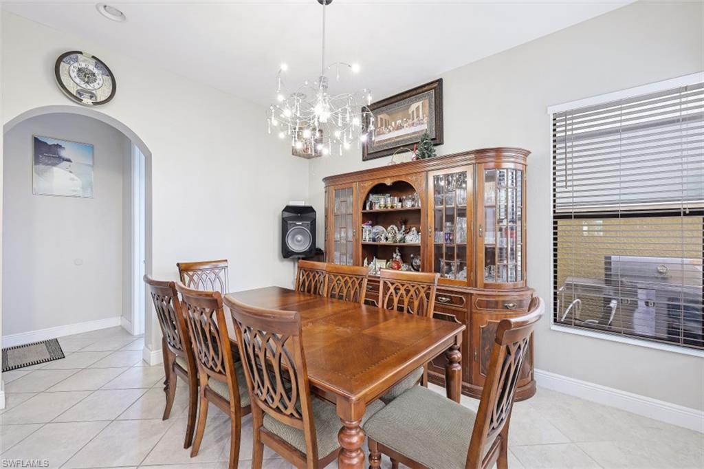 1316 Kendari Terrace Naples, FL 34113 - Photo 8 of 31 a view of a dining room with furniture window and wooden floor