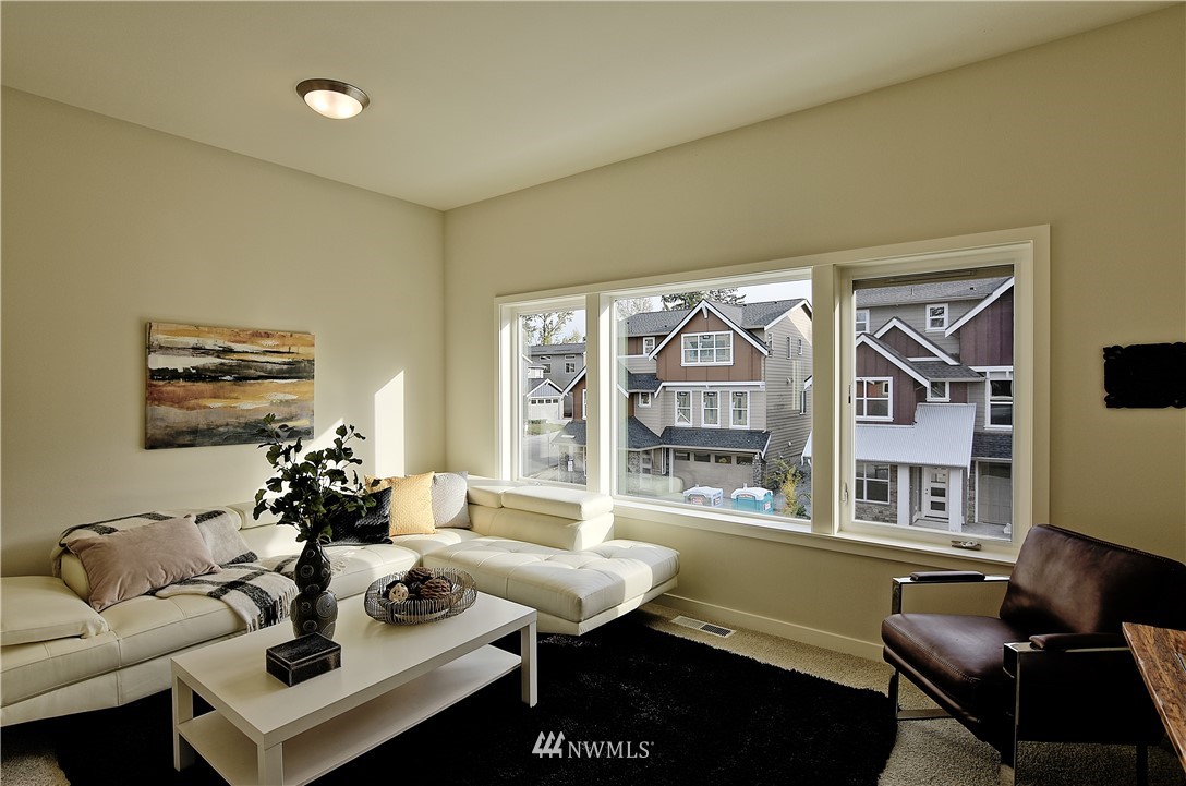 4317 232nd Place Southeast, Unit 10 Bothell, WA 98021 - Photo 22 of 24 a living room with furniture and a floor to ceiling window