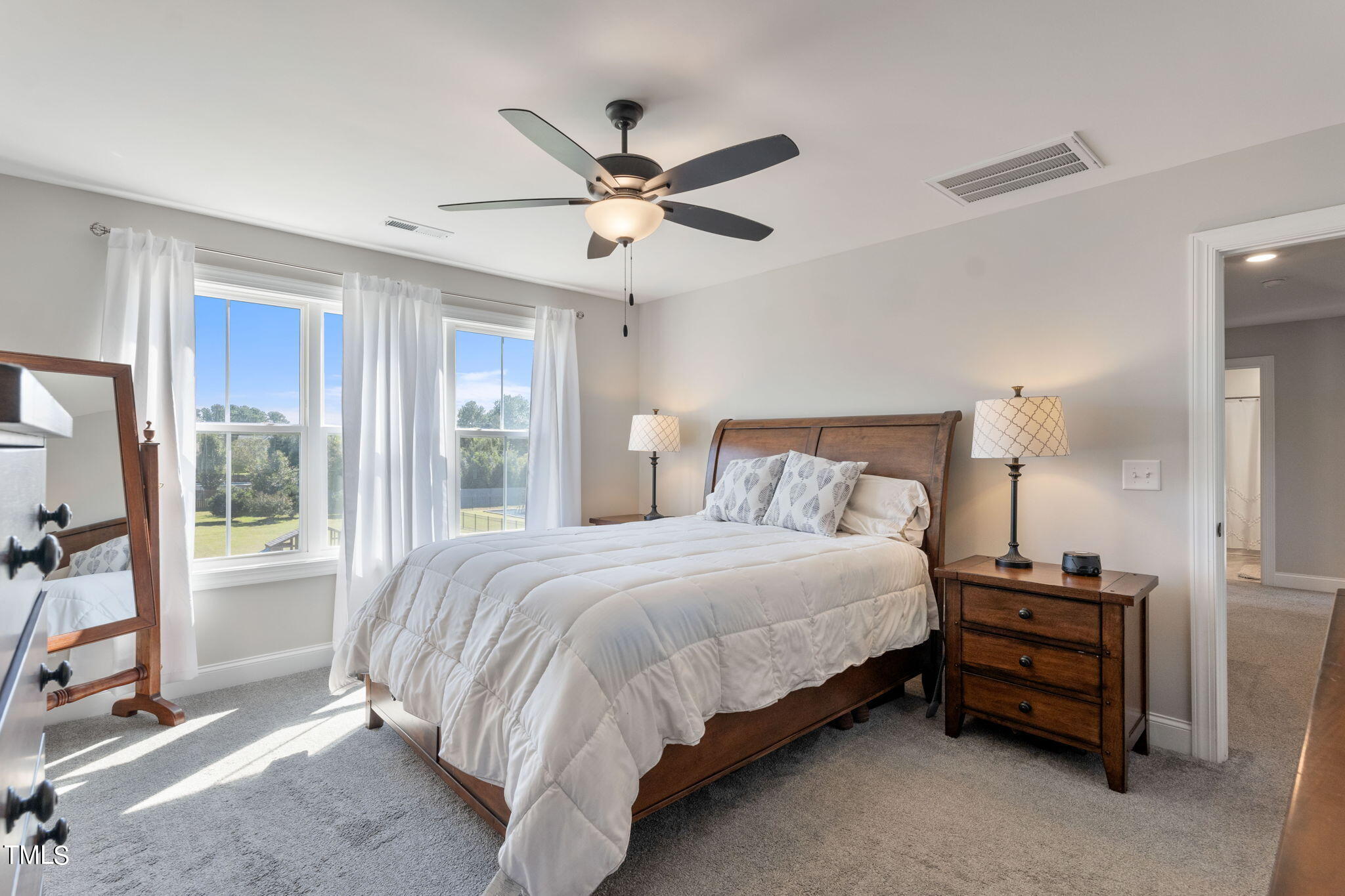 6217 Mal Weathers Road Raleigh, NC 27603 - Photo 45 of 59 a bedroom with a bed and large window