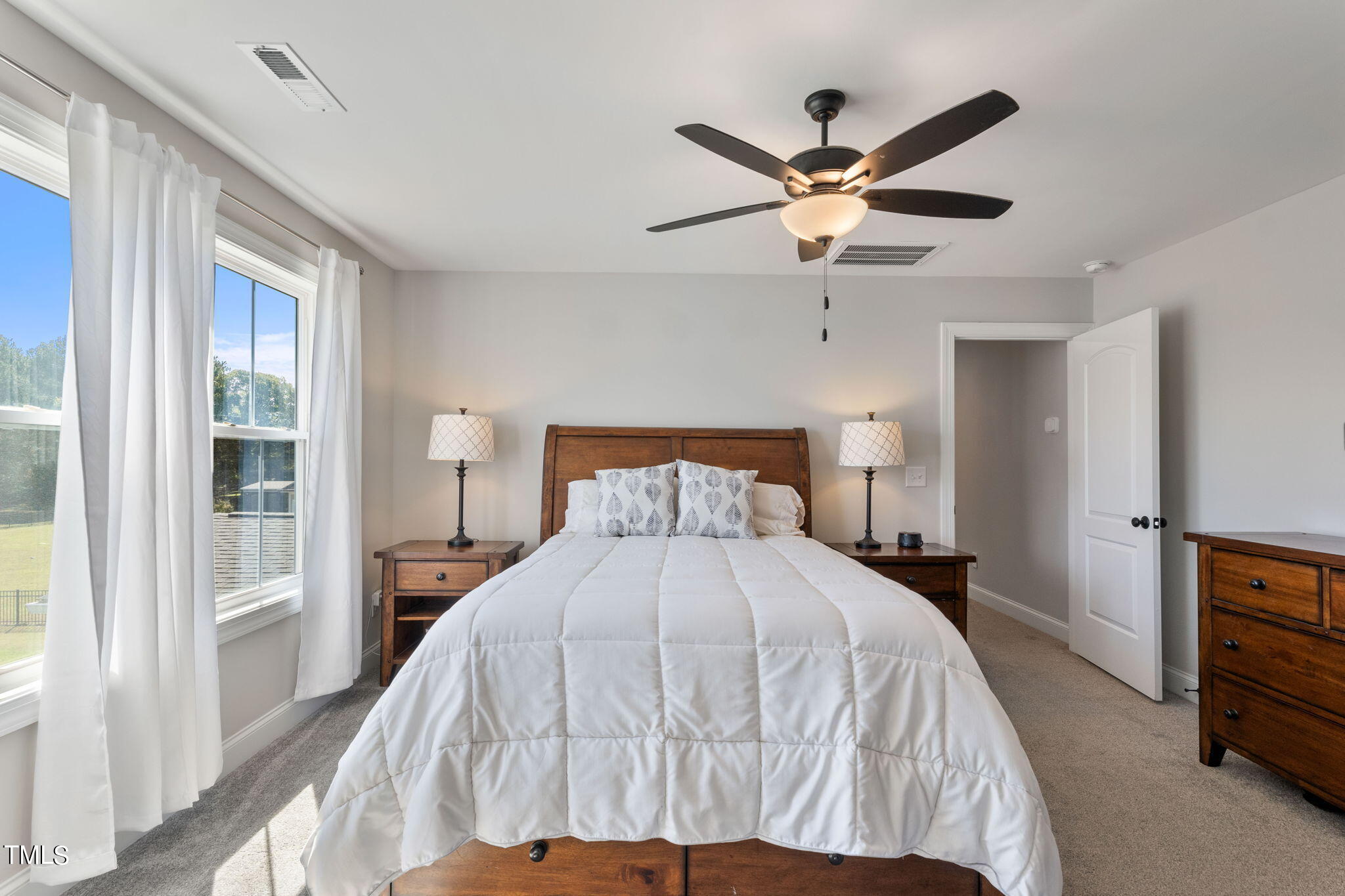 6217 Mal Weathers Road Raleigh, NC 27603 - Photo 46 of 59 a bedroom with a bed and a ceiling fan