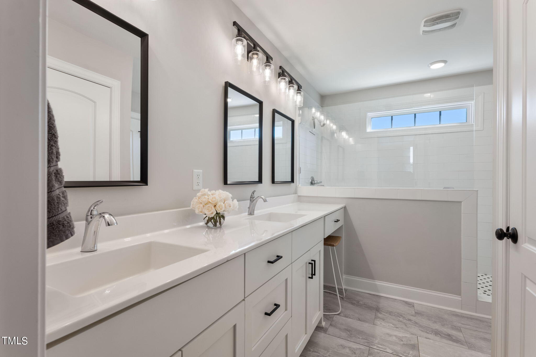 6217 Mal Weathers Road Raleigh, NC 27603 - Photo 53 of 59 a bathroom with a double vanity sink and a mirror
