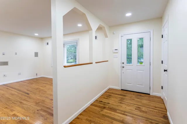 a view of a room with wooden floor and white doors
