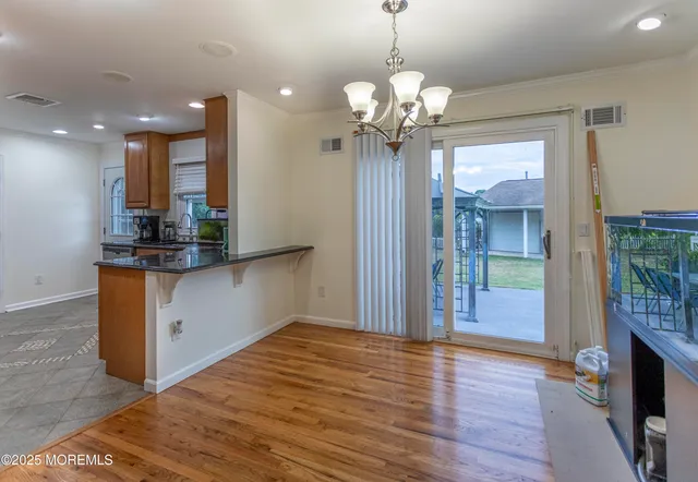 a view of a kitchen with granite countertop stainless steel appliances and wooden floor