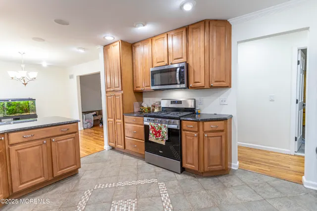 a kitchen with stainless steel appliances granite countertop a refrigerator and a stove top oven