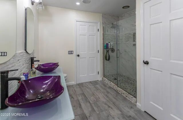 a spacious bedroom with a bed and wooden floor