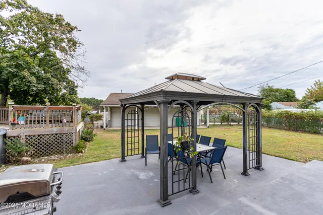 a view of a chair and table in the patio and a garden