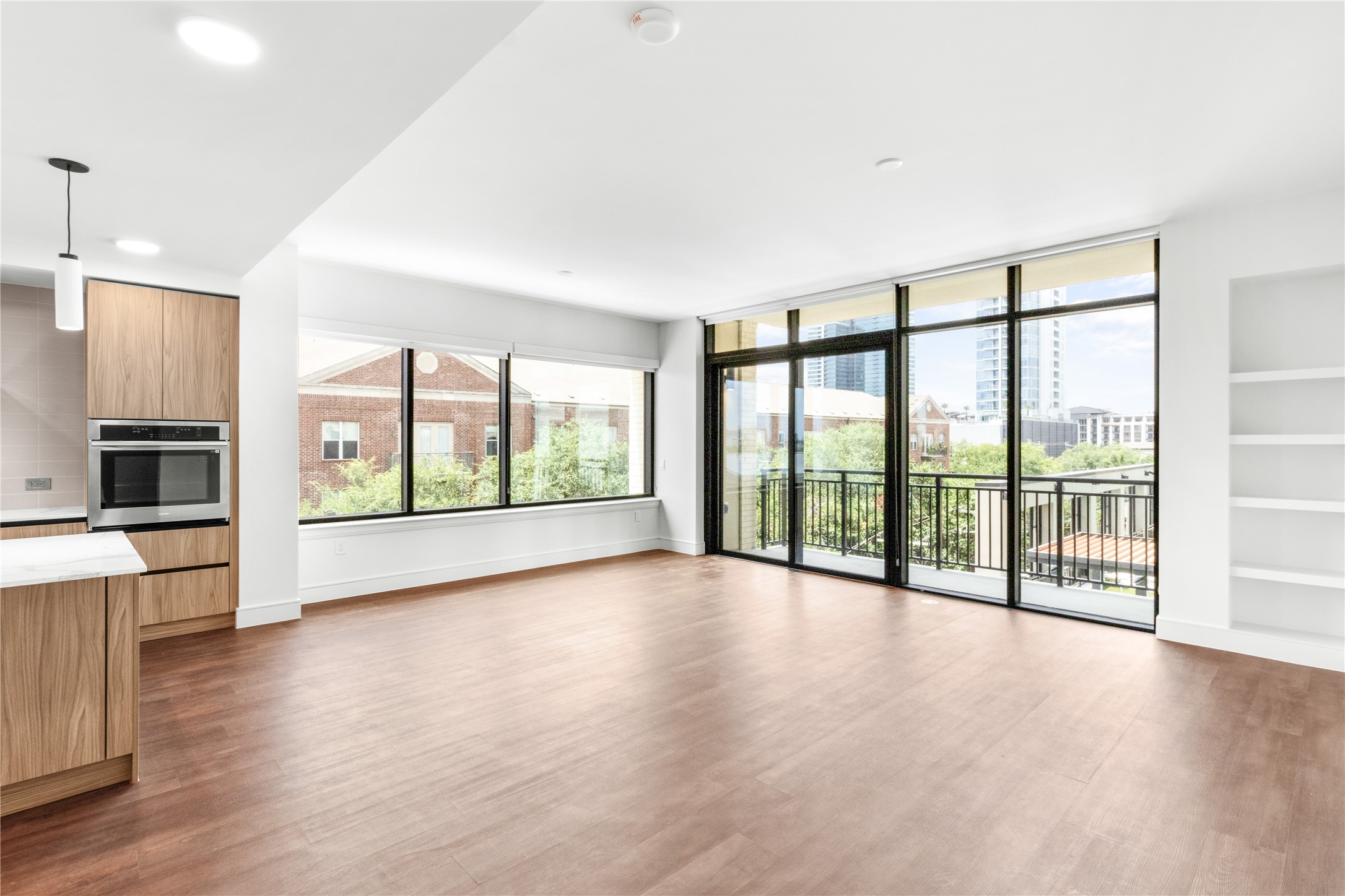 2311 Westheimer Road, Unit 529 Houston, TX 77098 - Photo 11 of 33 a view of an empty room with a window and wooden floor