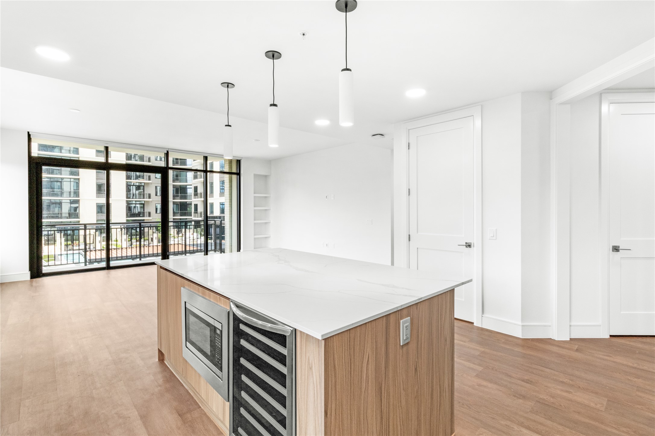 2311 Westheimer Road, Unit 529 Houston, TX 77098 - Photo 13 of 33 a view of an empty room with a window and wooden floor