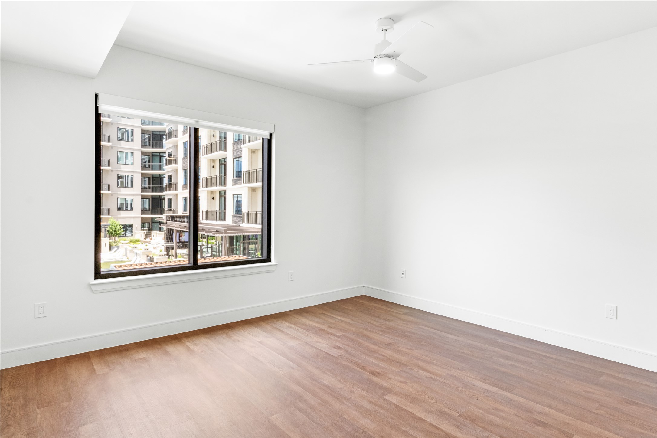 2311 Westheimer Road, Unit 529 Houston, TX 77098 - Photo 18 of 33 an empty room with wooden floor and windows
