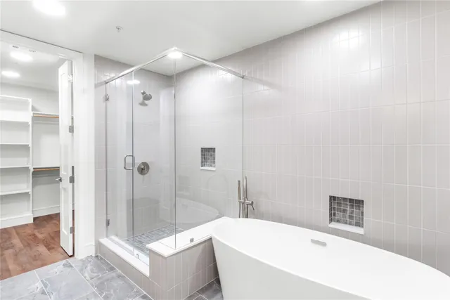 a bathroom with a bathtub and shower
