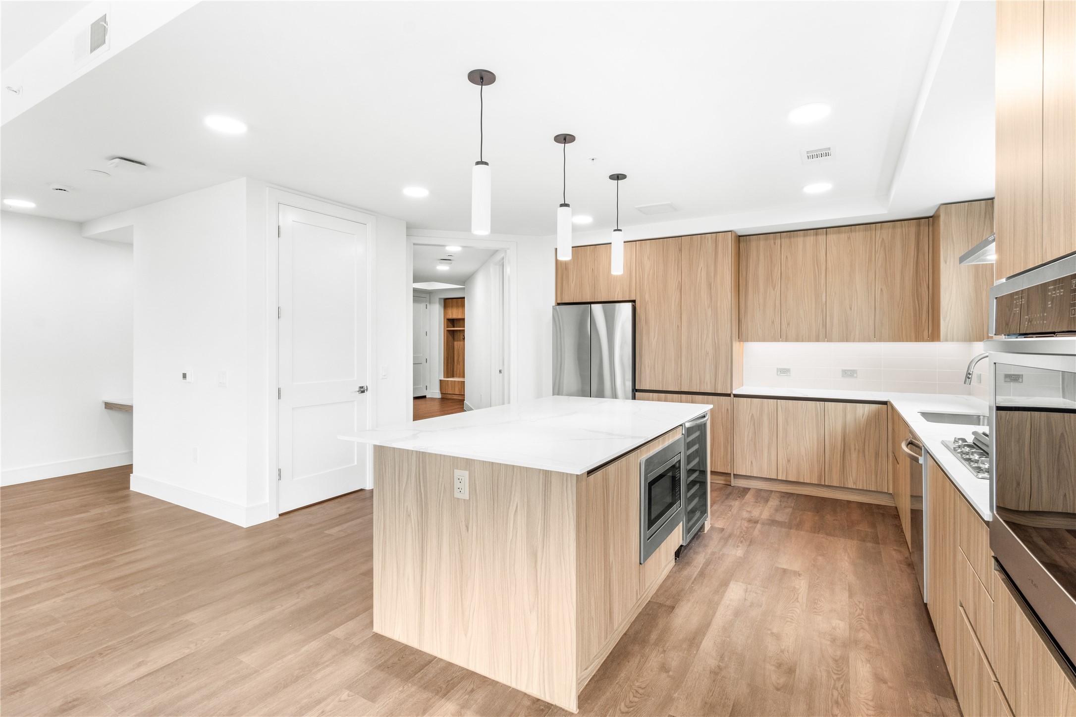 2311 Westheimer Road, Unit 529 Houston, TX 77098 - Photo 5 of 33 a kitchen with a sink a counter top space stainless steel appliances and a ceiling fan