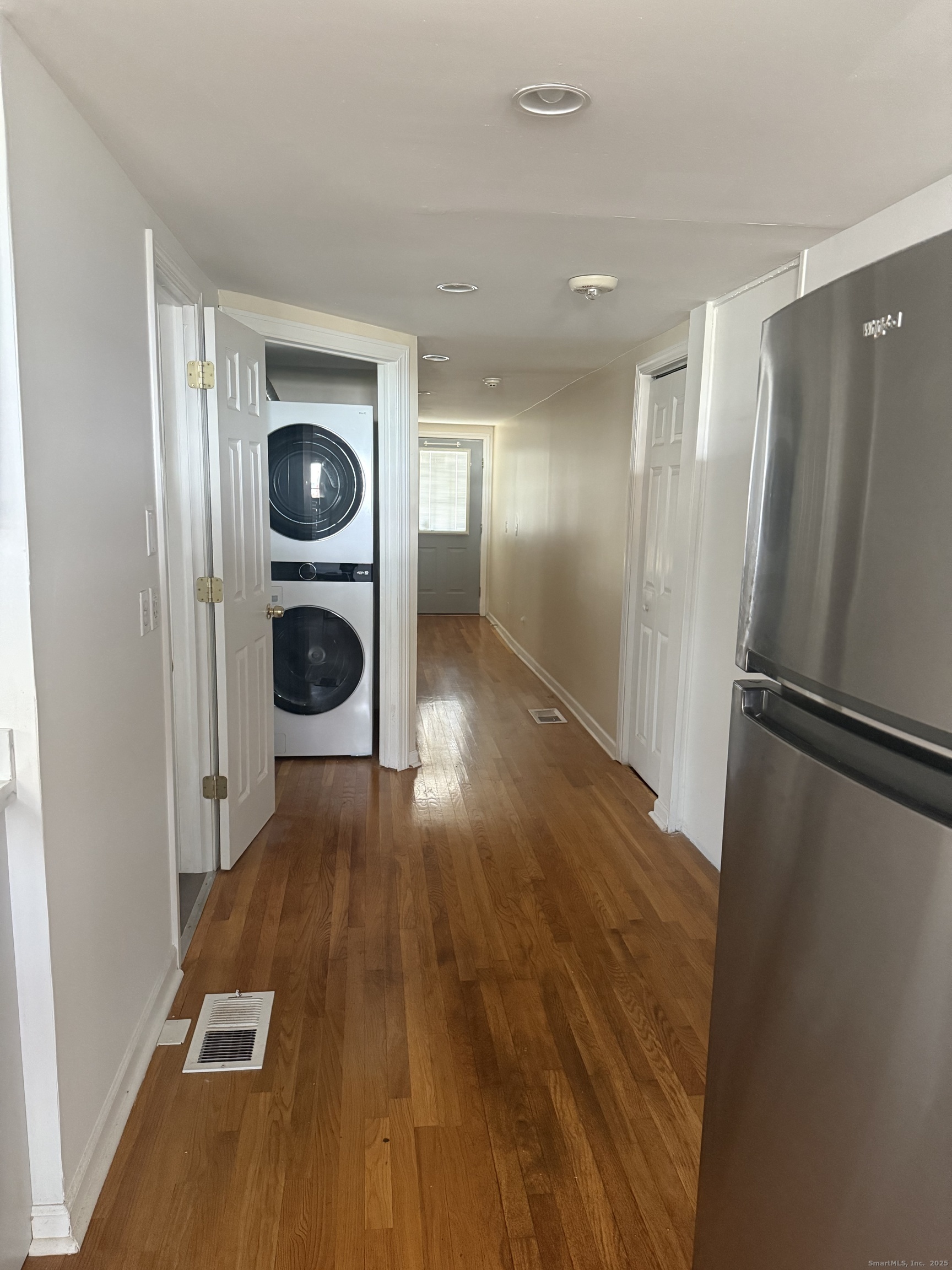 1347 East Main Street Meriden, CT 06450 - Photo 3 of 4 a view of a refrigerator in kitchen and wooden floor