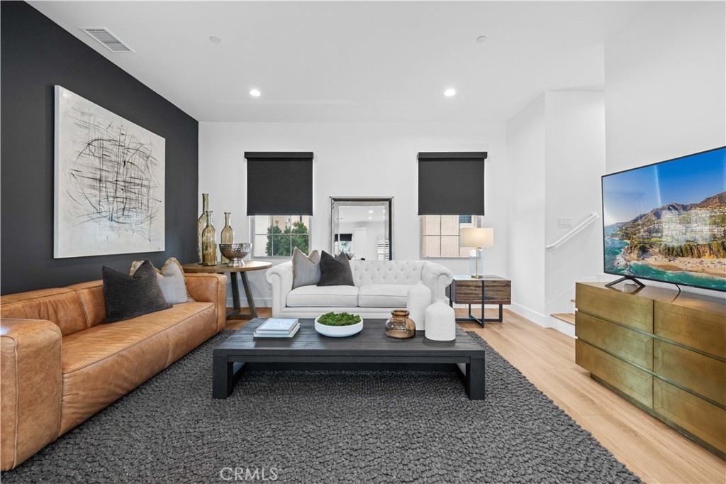 89 Kestrel Irvine, CA 92618 - Photo 16 of 45 a living room with furniture and wooden floor