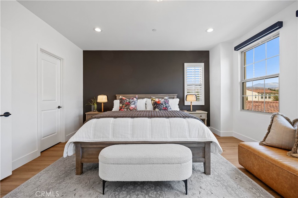 89 Kestrel Irvine, CA 92618 - Photo 31 of 45 a bedroom with a bed and wooden floor