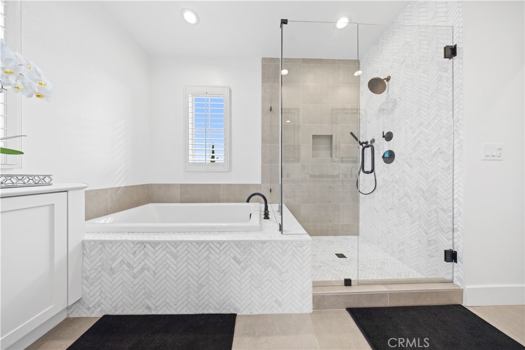 89 Kestrel Irvine, CA 92618 - Photo 33 of 45 a bathroom with a bathtub and a shower