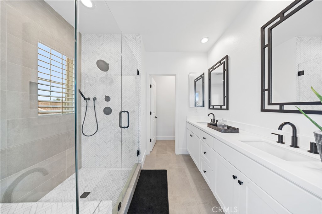 89 Kestrel Irvine, CA 92618 - Photo 34 of 45 a bathroom with a double vanity sink mirror double and shower