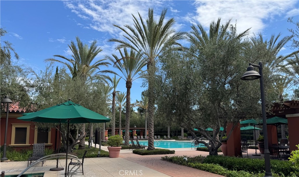89 Kestrel Irvine, CA 92618 - Photo 38 of 45 a view of a table and chairs under an umbrella with palm trees