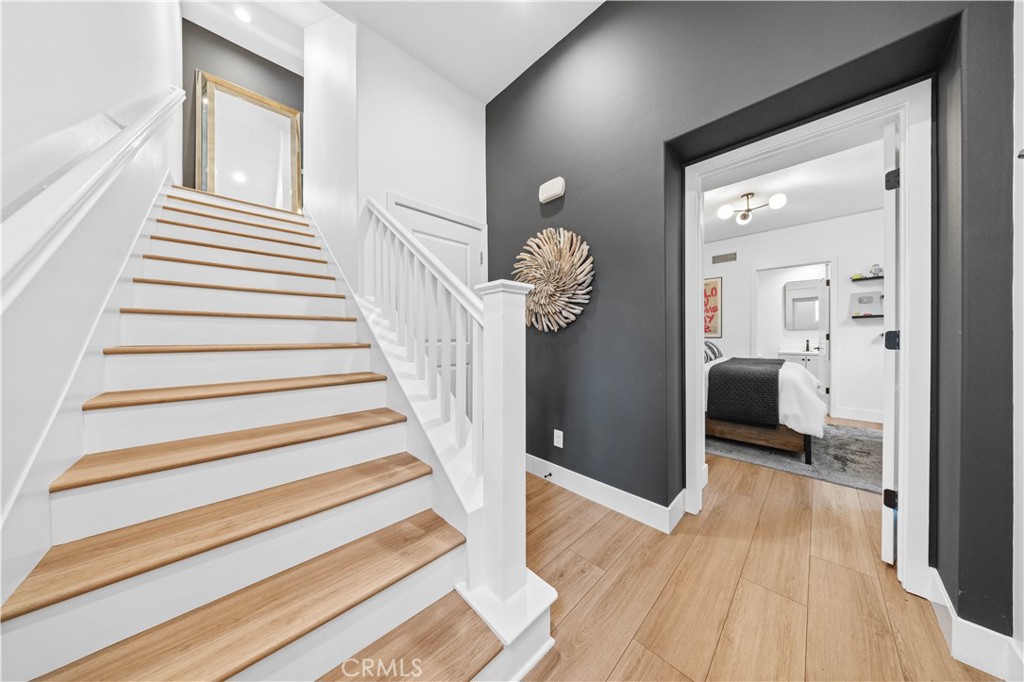 89 Kestrel Irvine, CA 92618 - Photo 8 of 45 a view of a hallway view with wooden floor and staircase