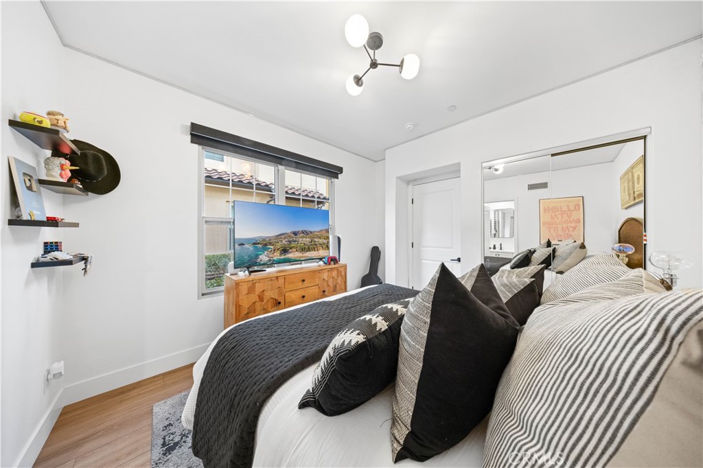 89 Kestrel Irvine, CA 92618 - Photo 10 of 45 a bedroom with a bed and wooden floor