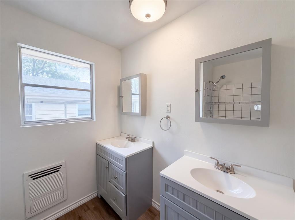 205 West Decatur Street Chico, TX 76431 - Photo 15 of 19 a bathroom with 2 sink and a mirror