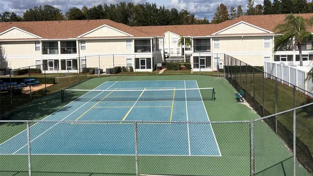 a view of a tennis ground with large windows