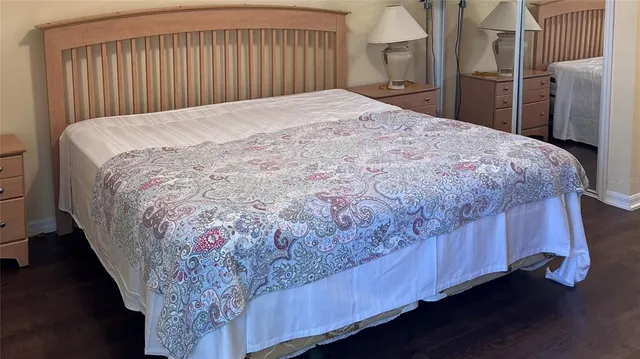 a large bed sitting in a bedroom next to a window