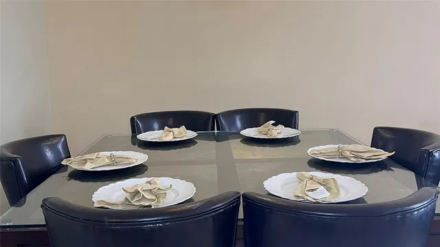 a view of a dining room with two table and a dining table with chairs
