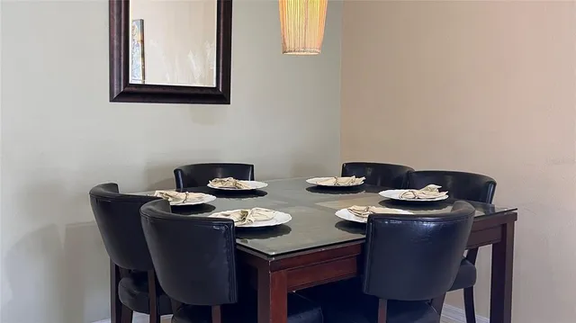 a dining room with chairs and table