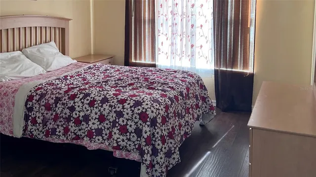 a bed sitting in a bedroom next to a window