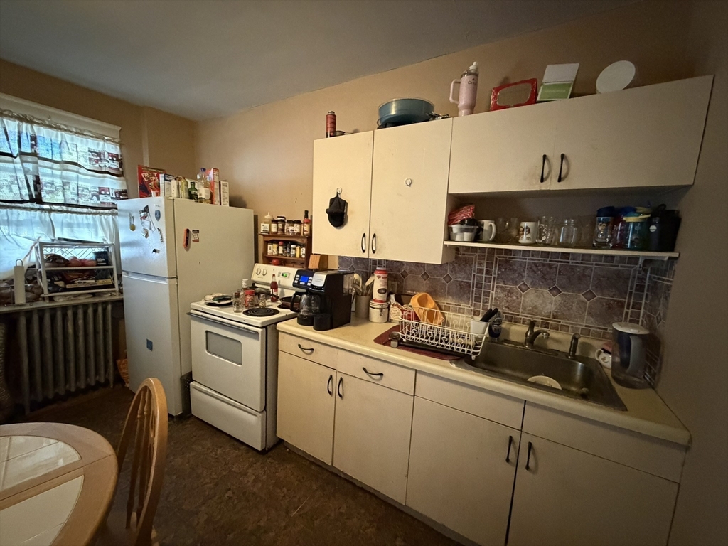 112 School Street Clinton, MA 01510 - Photo 14 of 20 a kitchen with a sink stainless steel appliances and cabinets