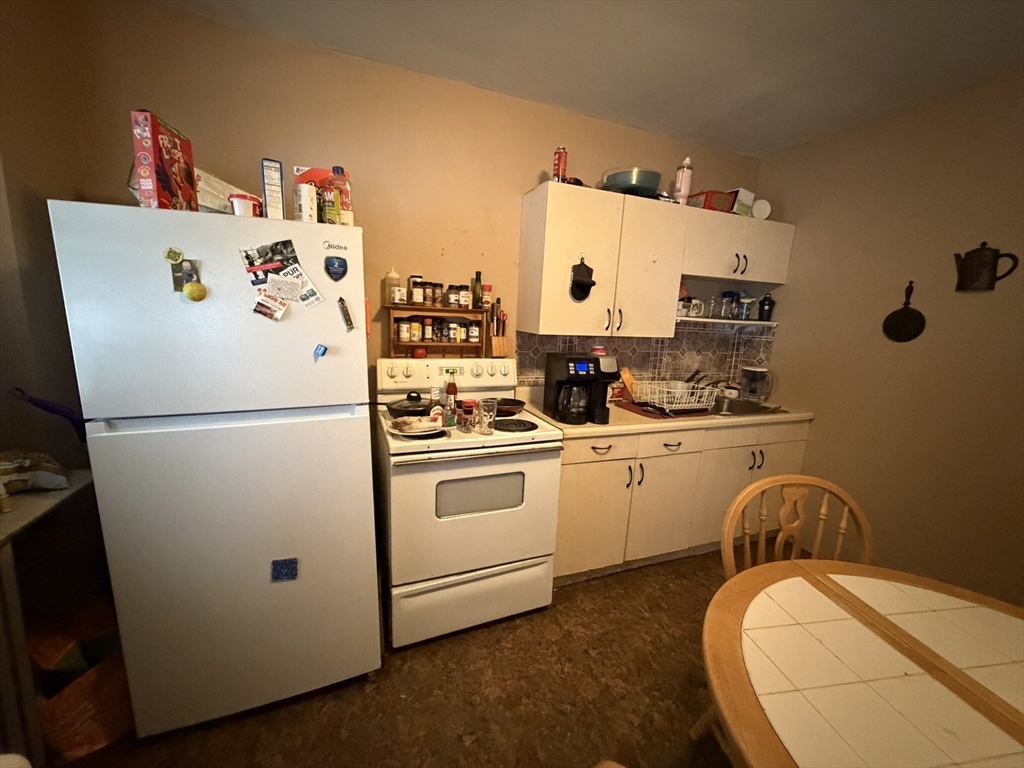 112 School Street Clinton, MA 01510 - Photo 15 of 20 a white refrigerator freezer sitting in a kitchen