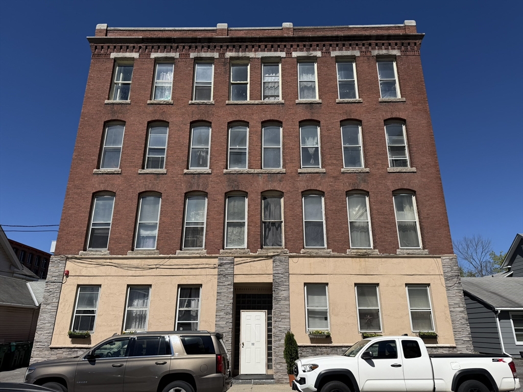 112 School Street Clinton, MA 01510 - Photo 2 of 20 a front view of a building with lot of windows