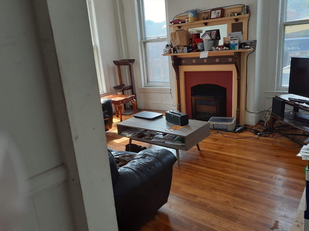 112 School Street Clinton, MA 01510 - Photo 8 of 20 a living room with furniture and a fireplace