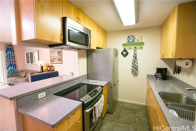95-520 Wikao Street, Unit B103 Mililani, HI 96789 - Photo 1 of 1 a kitchen with a sink stove and refrigerator