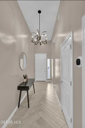 a view of a room with wooden floor and mirror