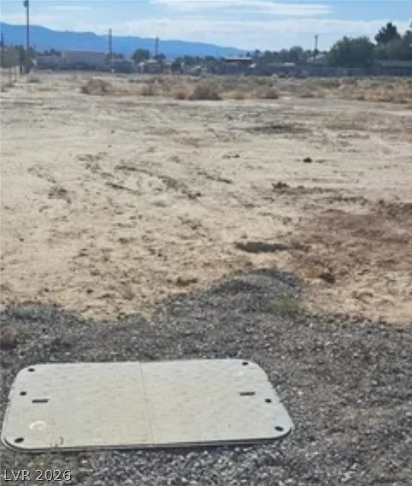 Vicky Ann Road Pahrump, NV 89048 - Photo 2 of 3 A vast, level lot awaits your vision, bordered by distant mountains and a community.