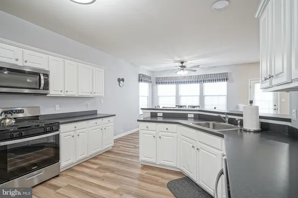 a kitchen with appliances a sink and cabinets