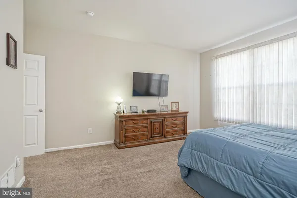 a bedroom with a bed and flat screen tv