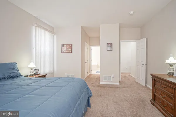 a bedroom with a bed and a lamp