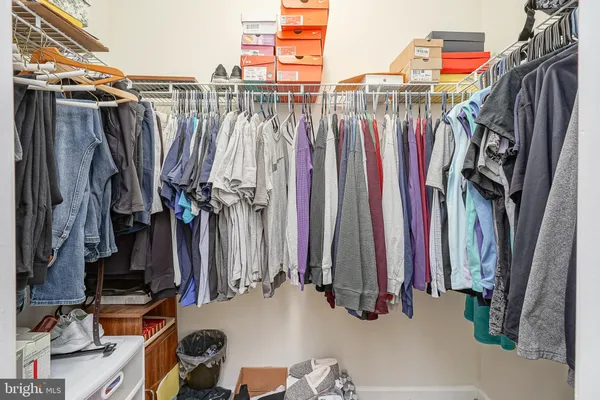 a view of walk in closet with clothes